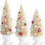 Cream Bottle Brush Trees w/Red Silver and Gold in UrnsCream Bottle Brush Trees w/Red Silver and Gold in Urns